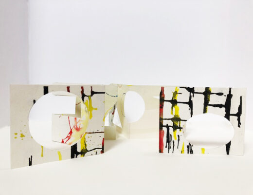 accordion folded watercolor paper with geometric shapes cut out, black yellow and red abstract marks painted